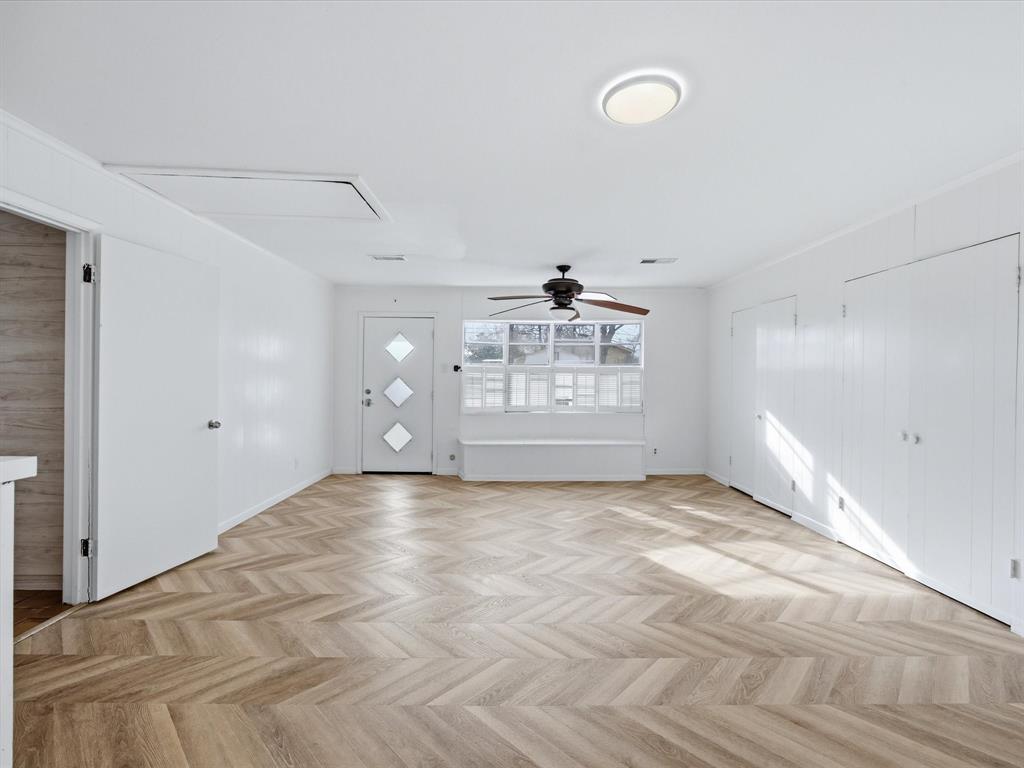 514 West Ridgewood Drive Garland, TX 75041 - Photo 18 of 39 Unfurnished living room featuring parquet flooring and a ceiling fan