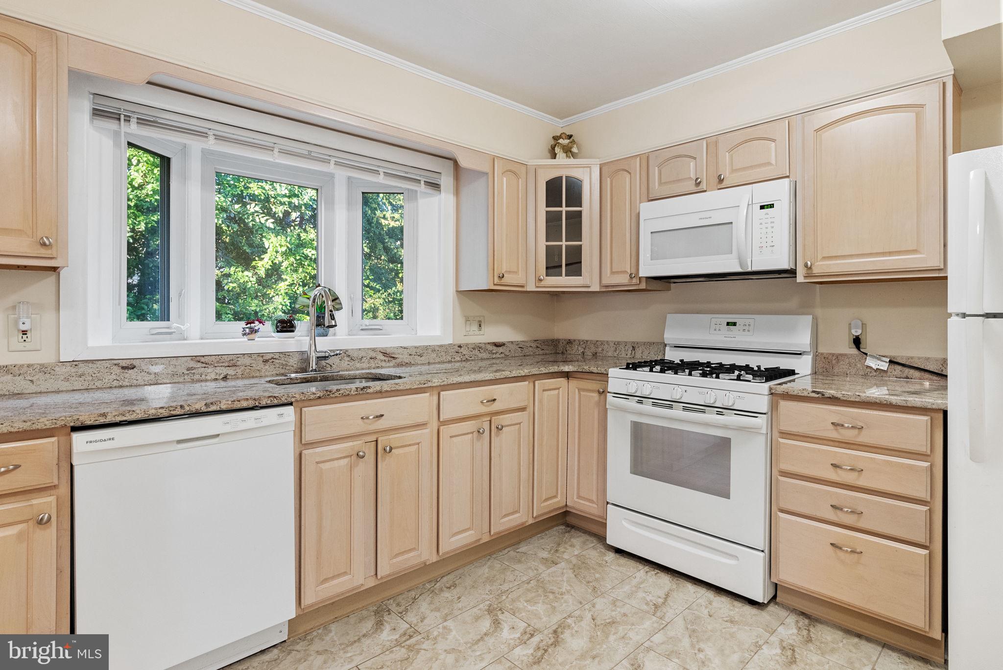 391 Rittenhouse Boulevard Eagleville, PA 19403 - Photo 11 of 43 a kitchen with granite countertop white cabinets and white appliances