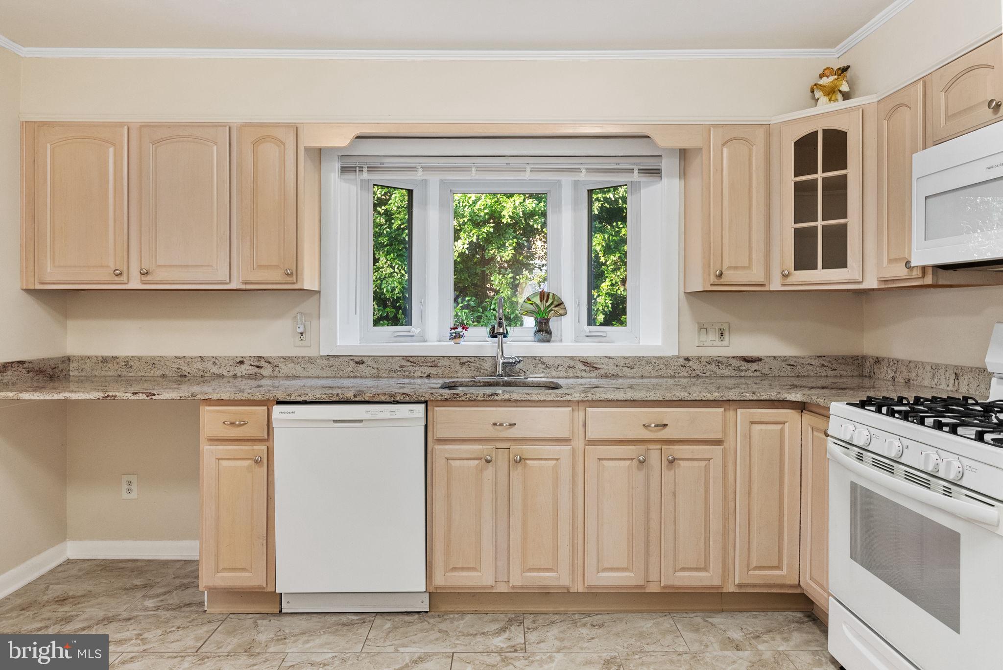 391 Rittenhouse Boulevard Eagleville, PA 19403 - Photo 12 of 43 a kitchen with granite countertop white cabinets and window