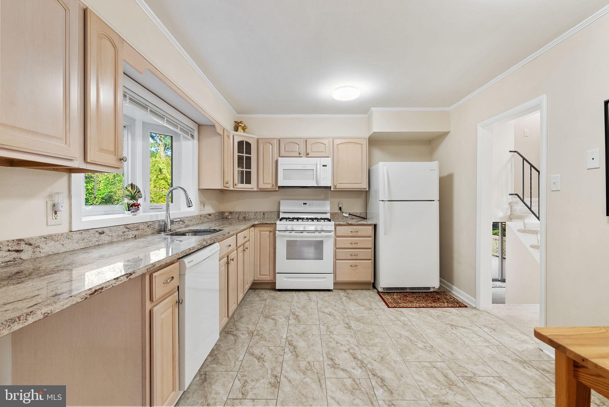 391 Rittenhouse Boulevard Eagleville, PA 19403 - Photo 10 of 43 a kitchen with white cabinets and appliances