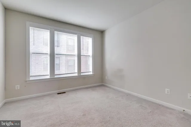 a view of an empty room and closet area