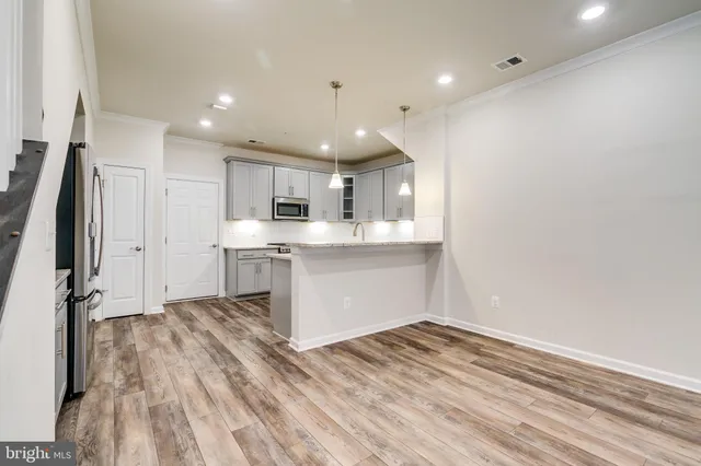 a view of kitchen with wooden floor