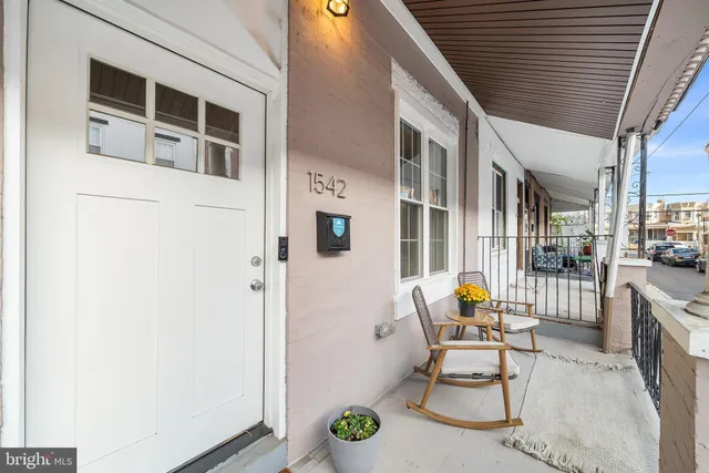 a view of a patio with chair and tables back yard of the house