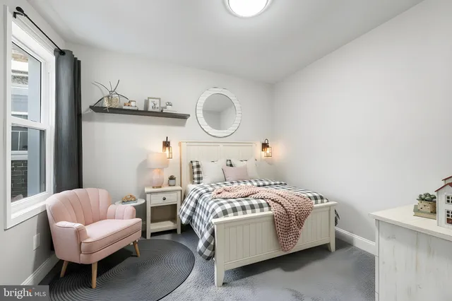 a bedroom with a bed couch and a window