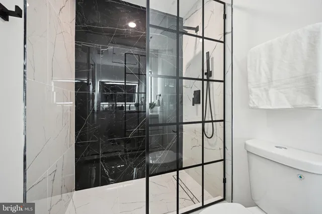 a bathroom with a glass shower door
