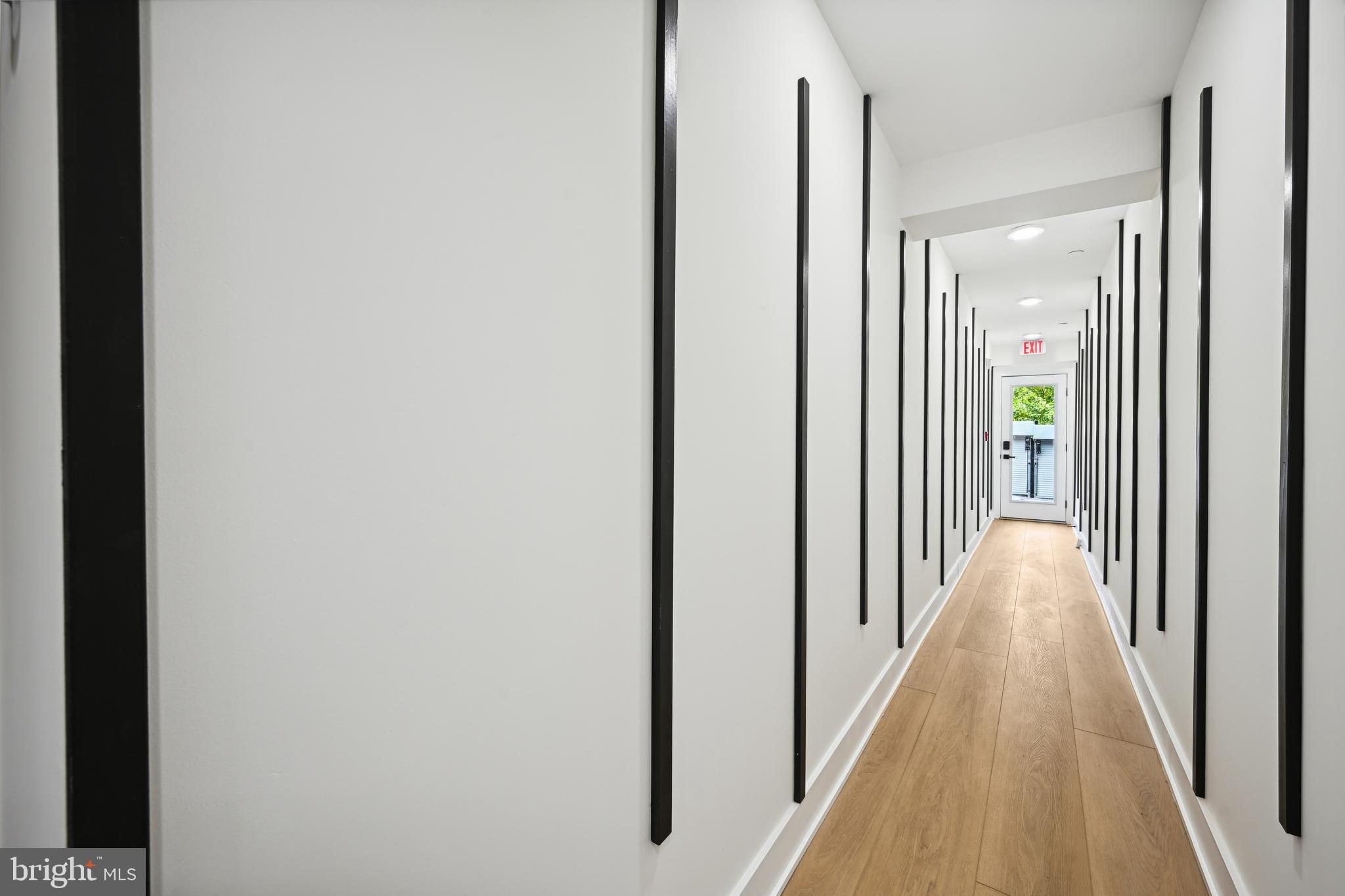 1372 Bryant Street Northeast, Unit 2A Washington, DC 20018 - Photo 20 of 22 a view of a hallway with wooden floor and staircase