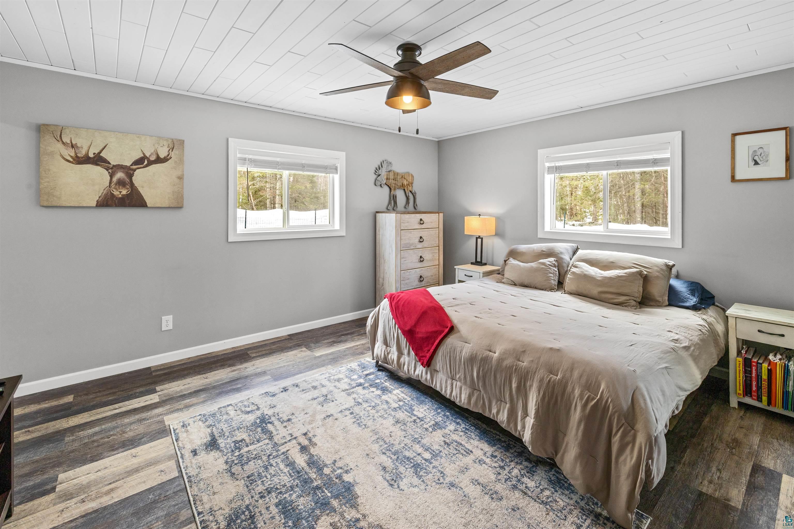 13462 Villa Road Ely, MN 55731 - Photo 15 of 68 Primary bedroom with Lifeproof flooring, wood ceiling, and ceiling fan, walk-in closet, en-suite bathroom