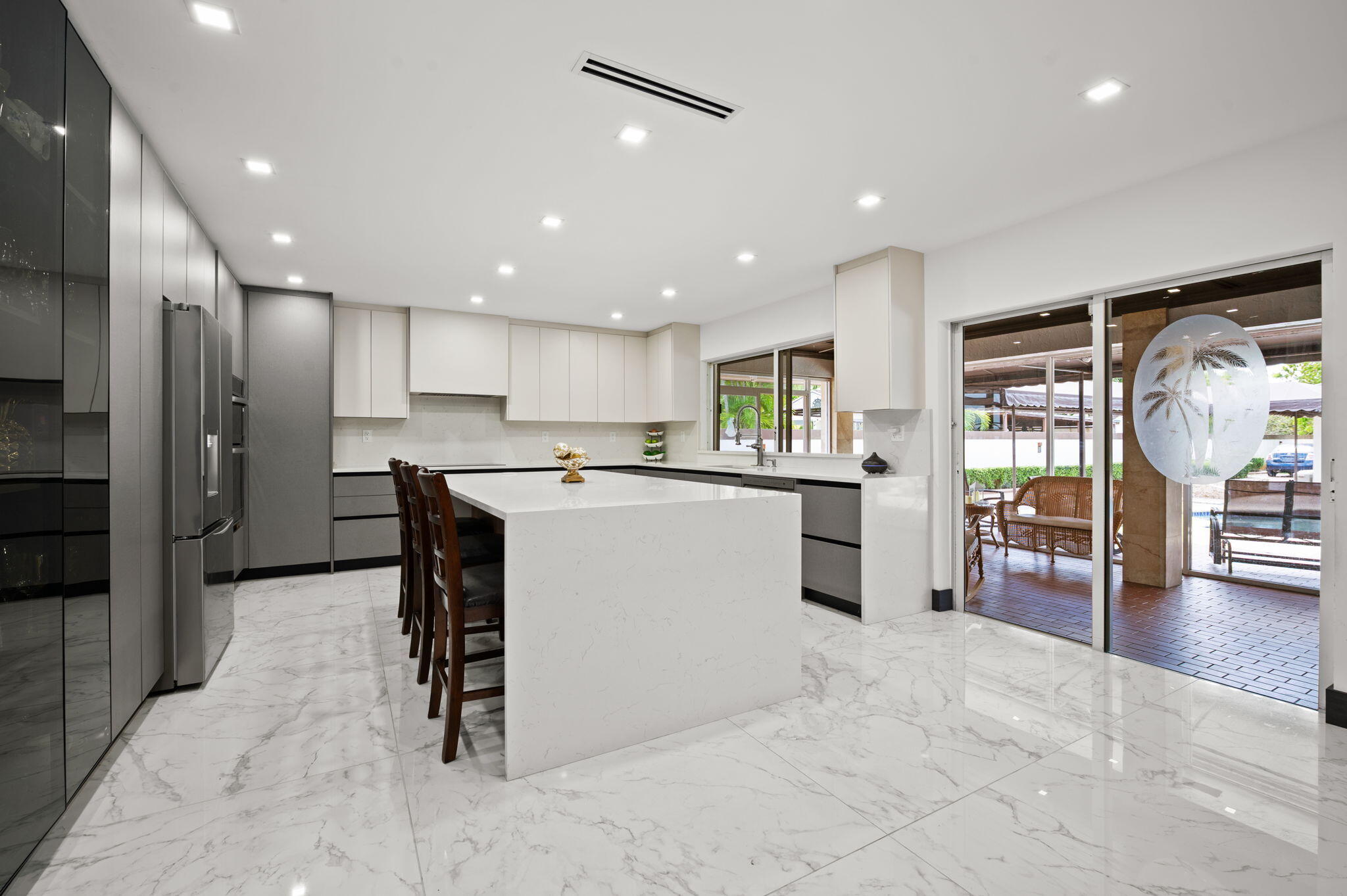 2840 Southwest 128th Avenue Miami, FL 33175 - Photo 14 of 46 a kitchen with stainless steel appliances kitchen island granite countertop a refrigerator and a sink