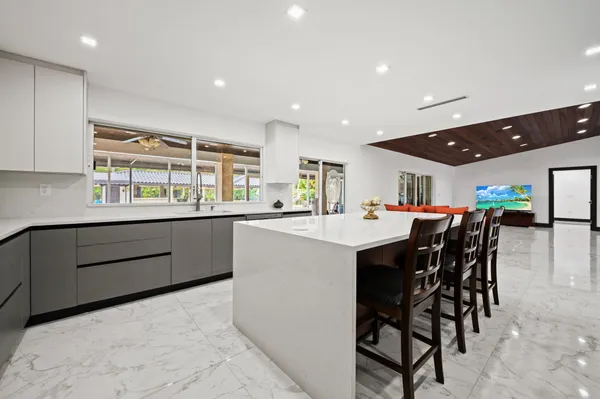 a bedroom with furniture and a large window