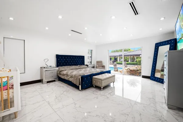 a spacious bedroom with a bed and a couch