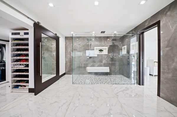 a view of walk in closet and bedroom