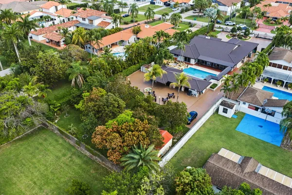 an aerial view of residential house with outdoor space and swimming pool
