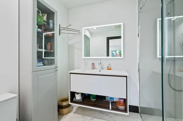a bathroom with a sink toilet and shower