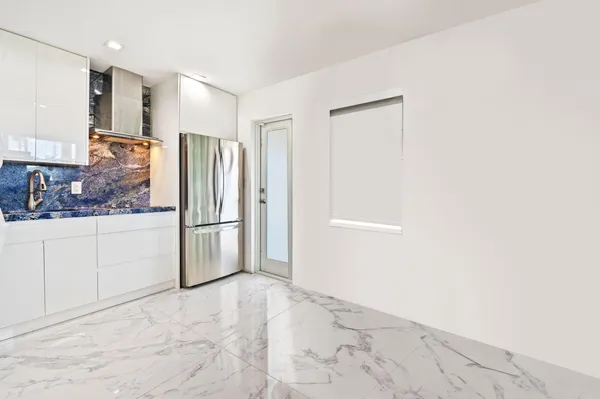 a bedroom with a large white bed and a flat screen tv