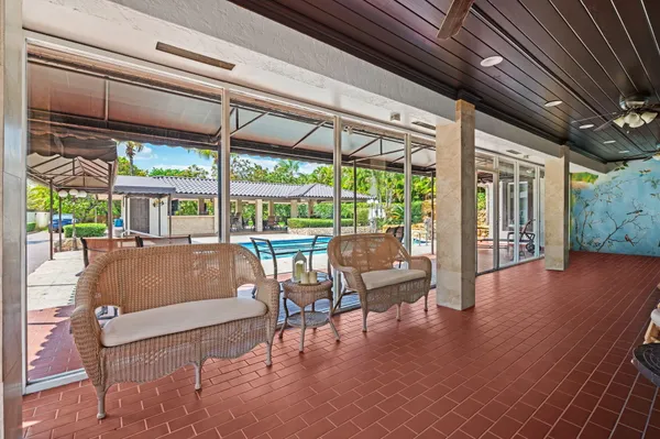 a view of a chairs and table in the balcony