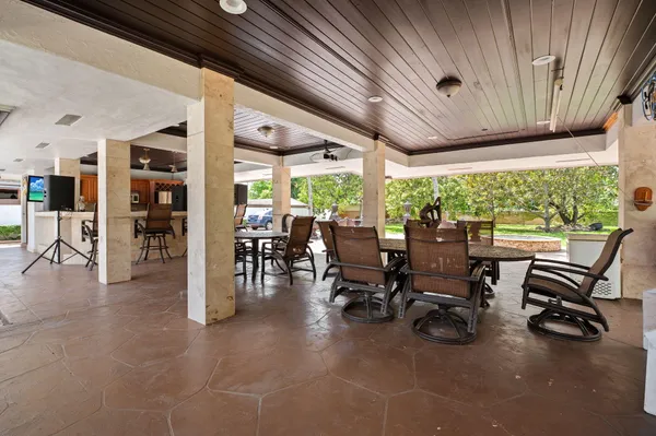 a kitchen with stainless steel appliances granite countertop a sink a stove and a refrigerator