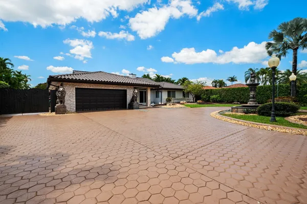a view of house with yard and swimming pool