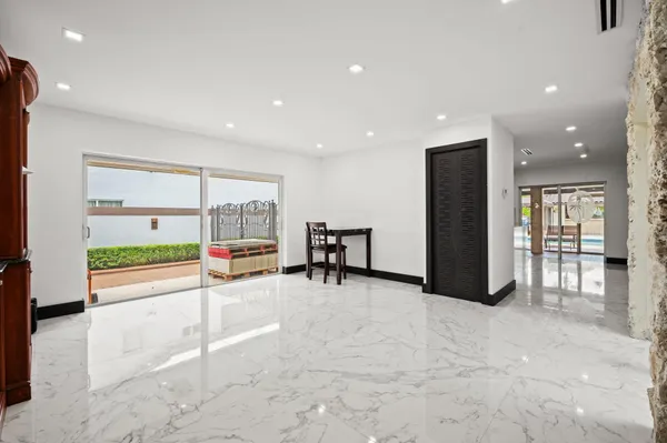 a view of a room with gym equipment and large windows