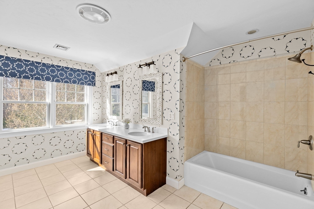 239 Washington Street, Unit 9 Norwell, MA 02061 - Photo 17 of 27 a bathroom with a bathtub a sink and a shower