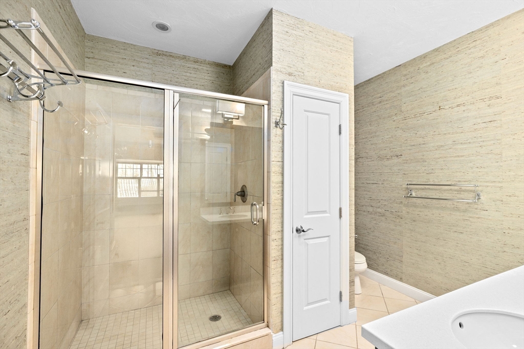 239 Washington Street, Unit 9 Norwell, MA 02061 - Photo 18 of 27 a bathroom with a glass shower door