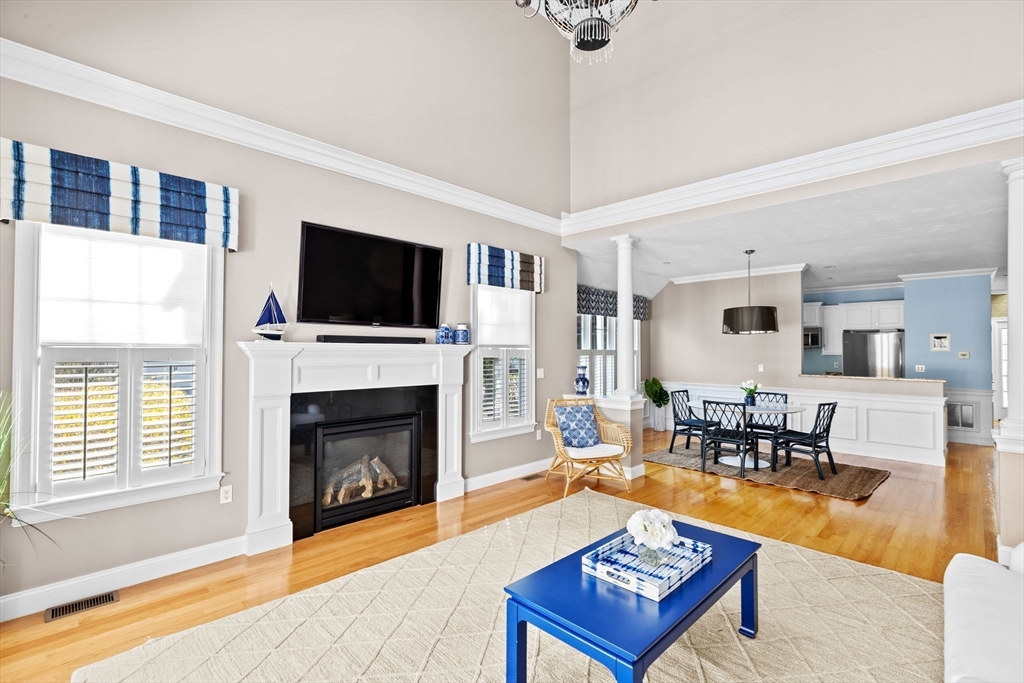 239 Washington Street, Unit 9 Norwell, MA 02061 - Photo 7 of 27 a living room with furniture a flat screen tv and a fireplace