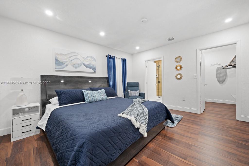 445 Southwest 62nd Court Miami, FL 33144 - Photo 15 of 41 a bedroom with a bed and wooden floor