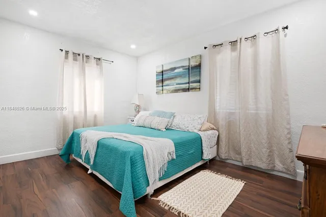 a bedroom with a bed and a mirror