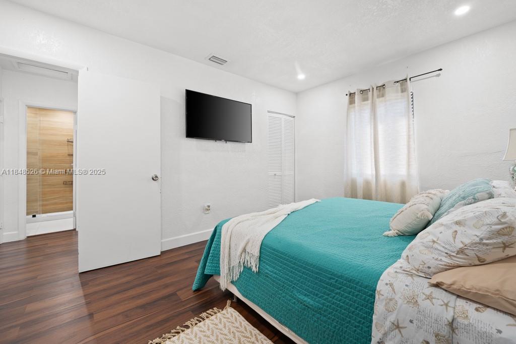 445 Southwest 62nd Court Miami, FL 33144 - Photo 21 of 41 a bedroom with a bed and a flat screen tv