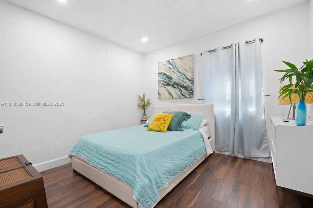 445 Southwest 62nd Court Miami, FL 33144 - Photo 23 of 41 a bedroom with a bed and a table