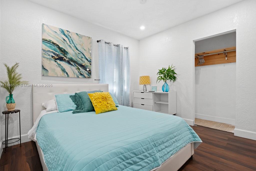 445 Southwest 62nd Court Miami, FL 33144 - Photo 24 of 41 a bedroom with a bed a painting on the wall and a potted plant
