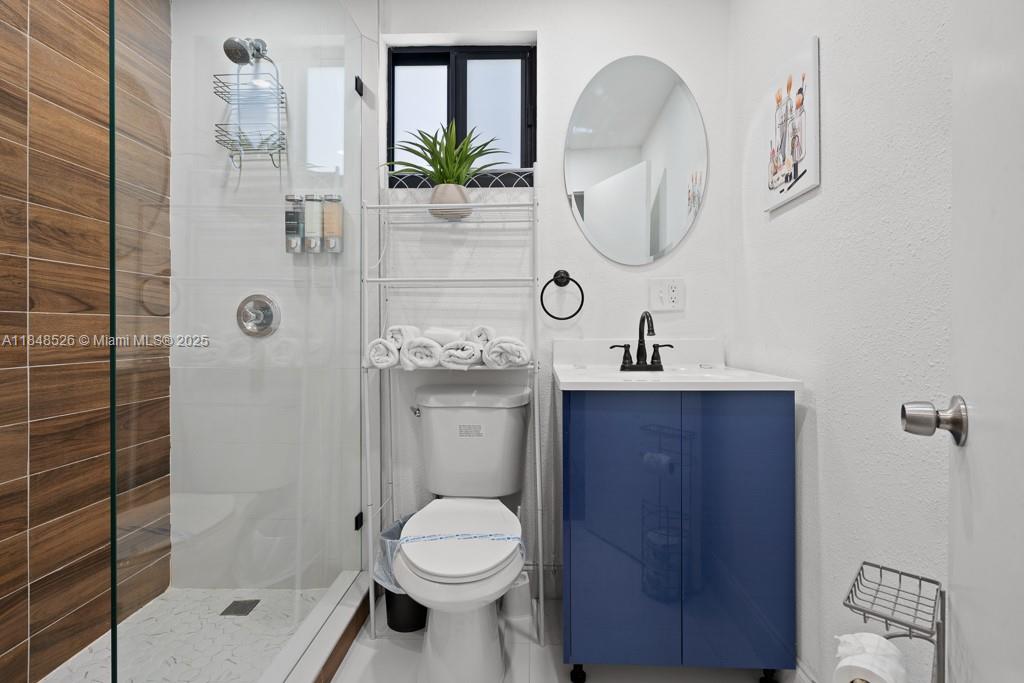 445 Southwest 62nd Court Miami, FL 33144 - Photo 26 of 41 a bathroom with a toilet a sink a shower and mirror