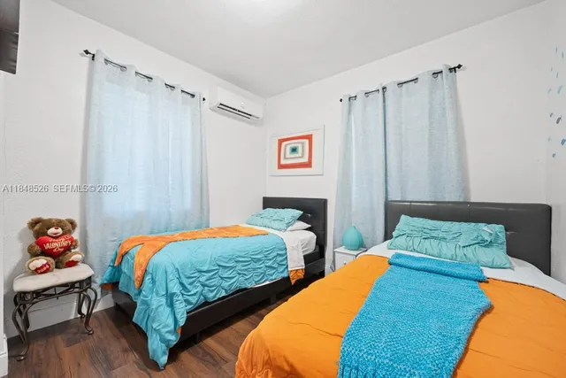 a bedroom with two beds and a closet