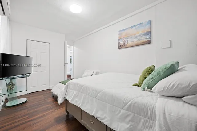 a bedroom with a bed and flat screen tv