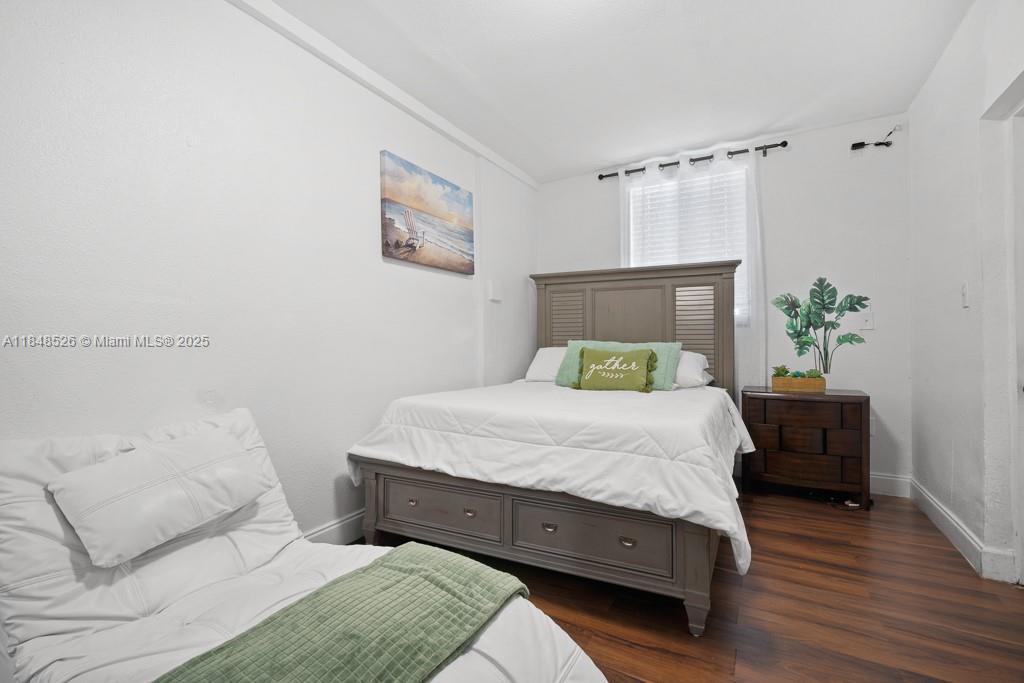 445 Southwest 62nd Court Miami, FL 33144 - Photo 32 of 41 a bedroom with a bed and a potted plant on the dresser