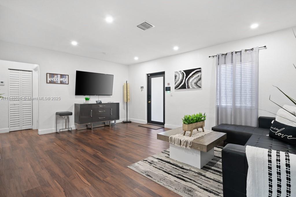 445 Southwest 62nd Court Miami, FL 33144 - Photo 5 of 41 a living room with furniture and a flat screen tv