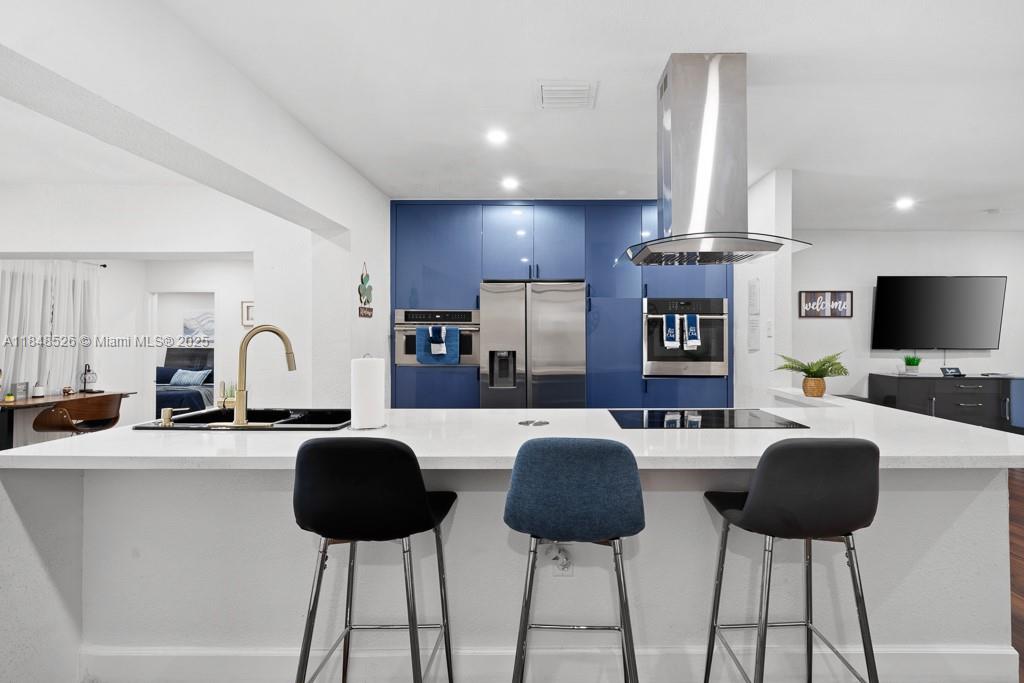 445 Southwest 62nd Court Miami, FL 33144 - Photo 7 of 41 a living room with furniture a flat screen tv and kitchen view