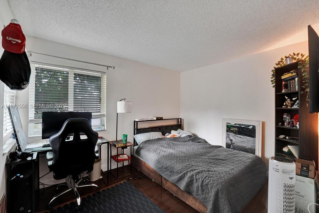 2747 Pinewood Court Davie, FL 33328 - Photo 17 of 25 a bedroom with a bed and wooden floor