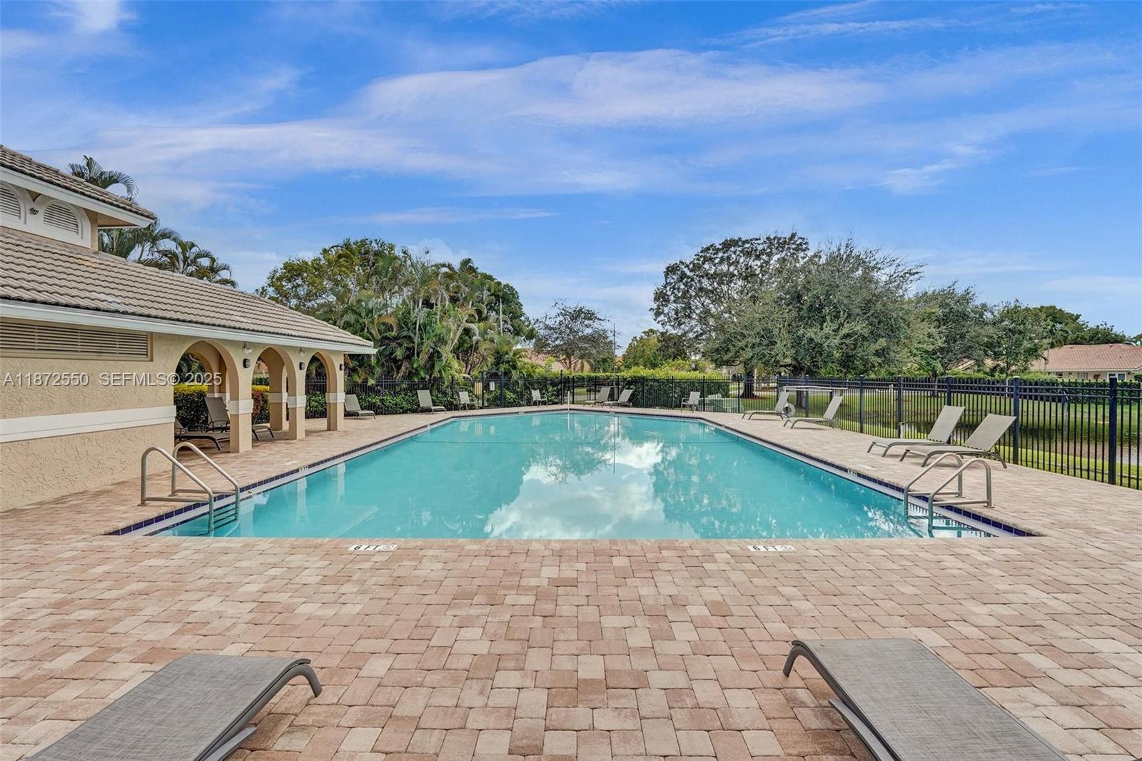 2747 Pinewood Court Davie, FL 33328 - Photo 21 of 25 a view of a house with a swimming pool