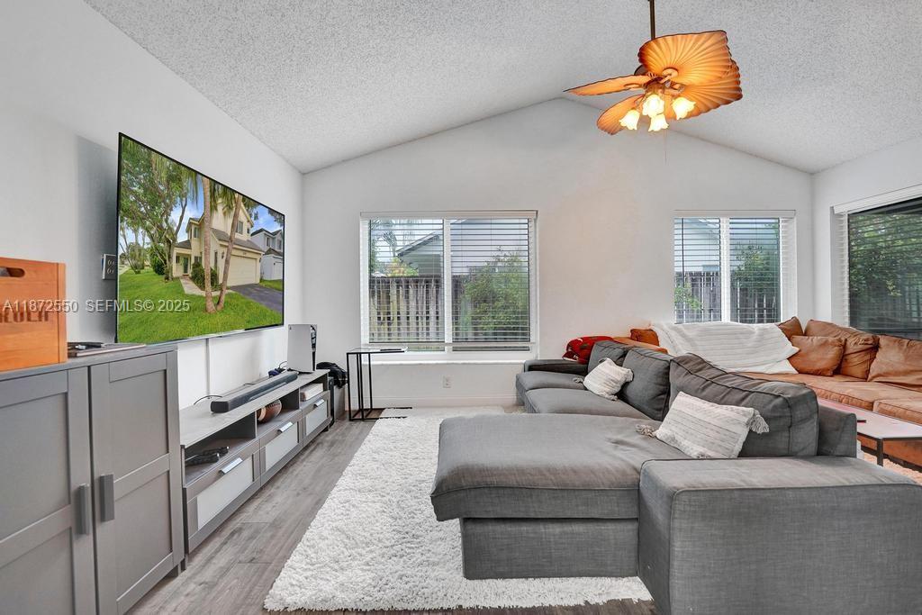 2747 Pinewood Court Davie, FL 33328 - Photo 3 of 25 a living room with furniture and a flat screen tv