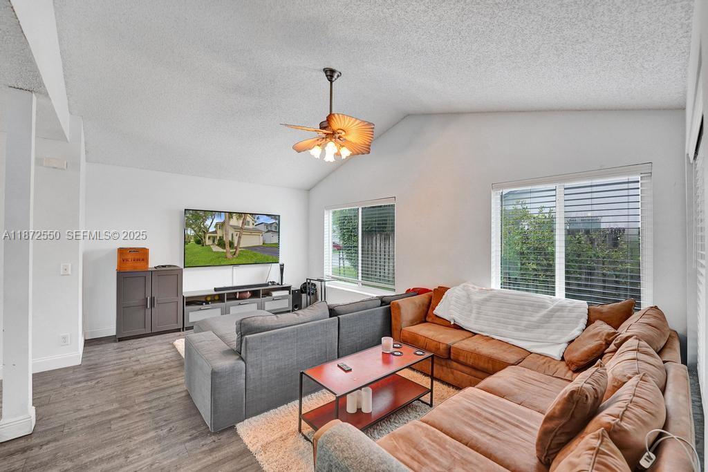 2747 Pinewood Court Davie, FL 33328 - Photo 4 of 25 a living room with furniture flat screen tv and a large window