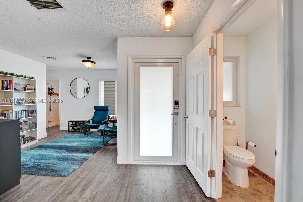2747 Pinewood Court Davie, FL 33328 - Photo 7 of 25 a living room with furniture and a wooden floor