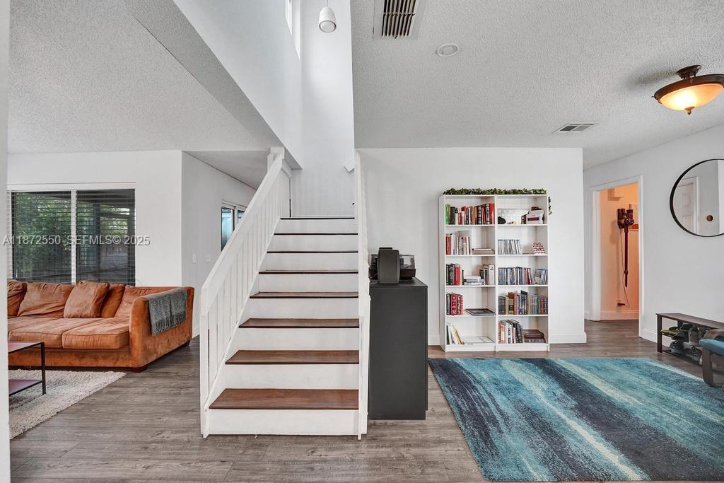 2747 Pinewood Court Davie, FL 33328 - Photo 9 of 25 a living room with furniture and a flat screen tv