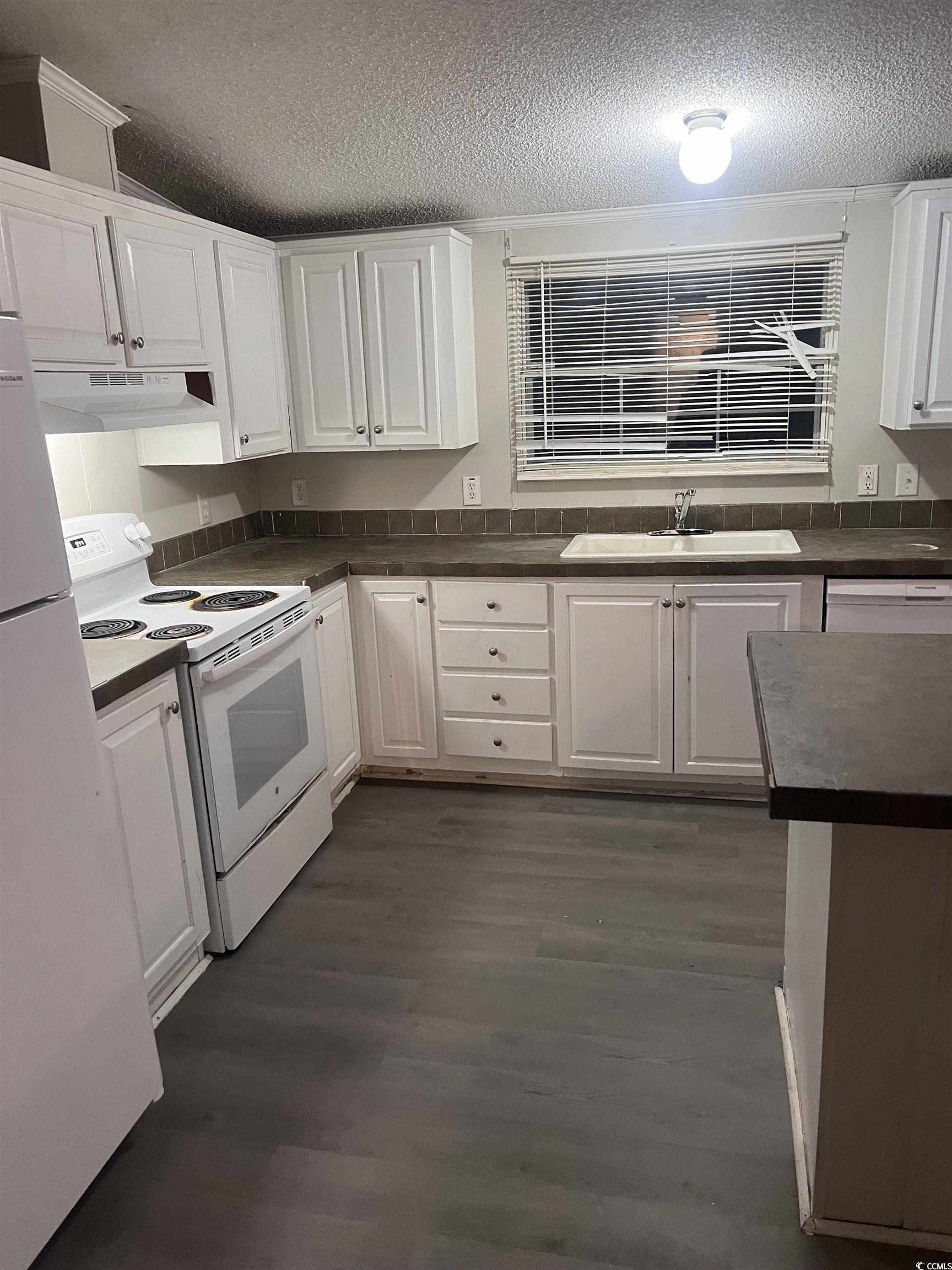 159 Jeffcoat Bridge Road North, SC 29112 - Photo 12 of 17 Kitchen featuring white appliances, a textured cei