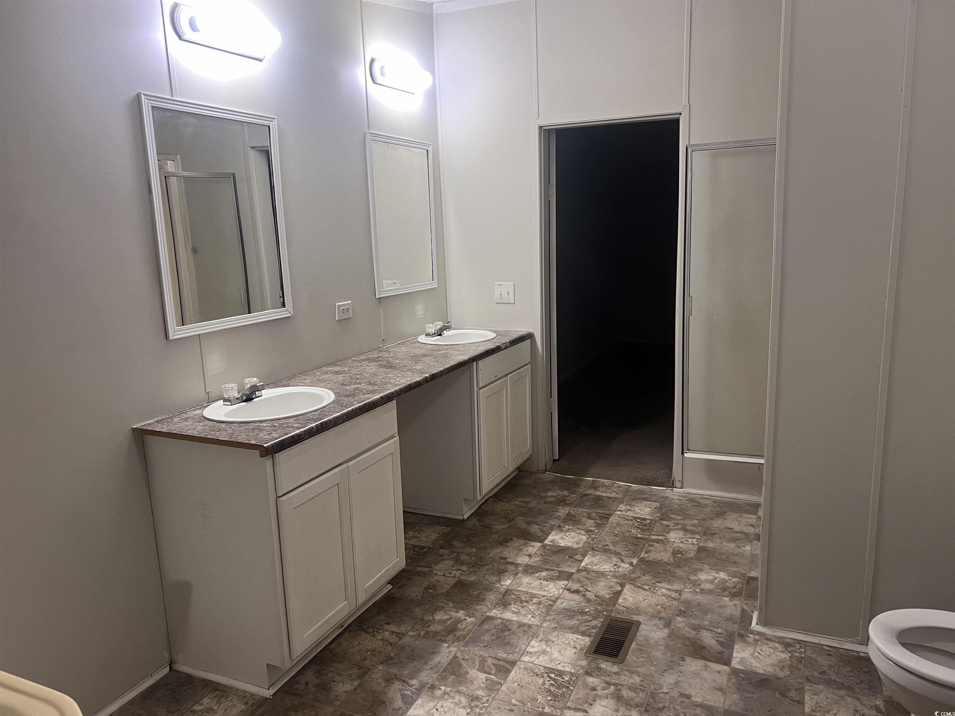 159 Jeffcoat Bridge Road North, SC 29112 - Photo 13 of 17 Bathroom with double vanity, stone finish floors,