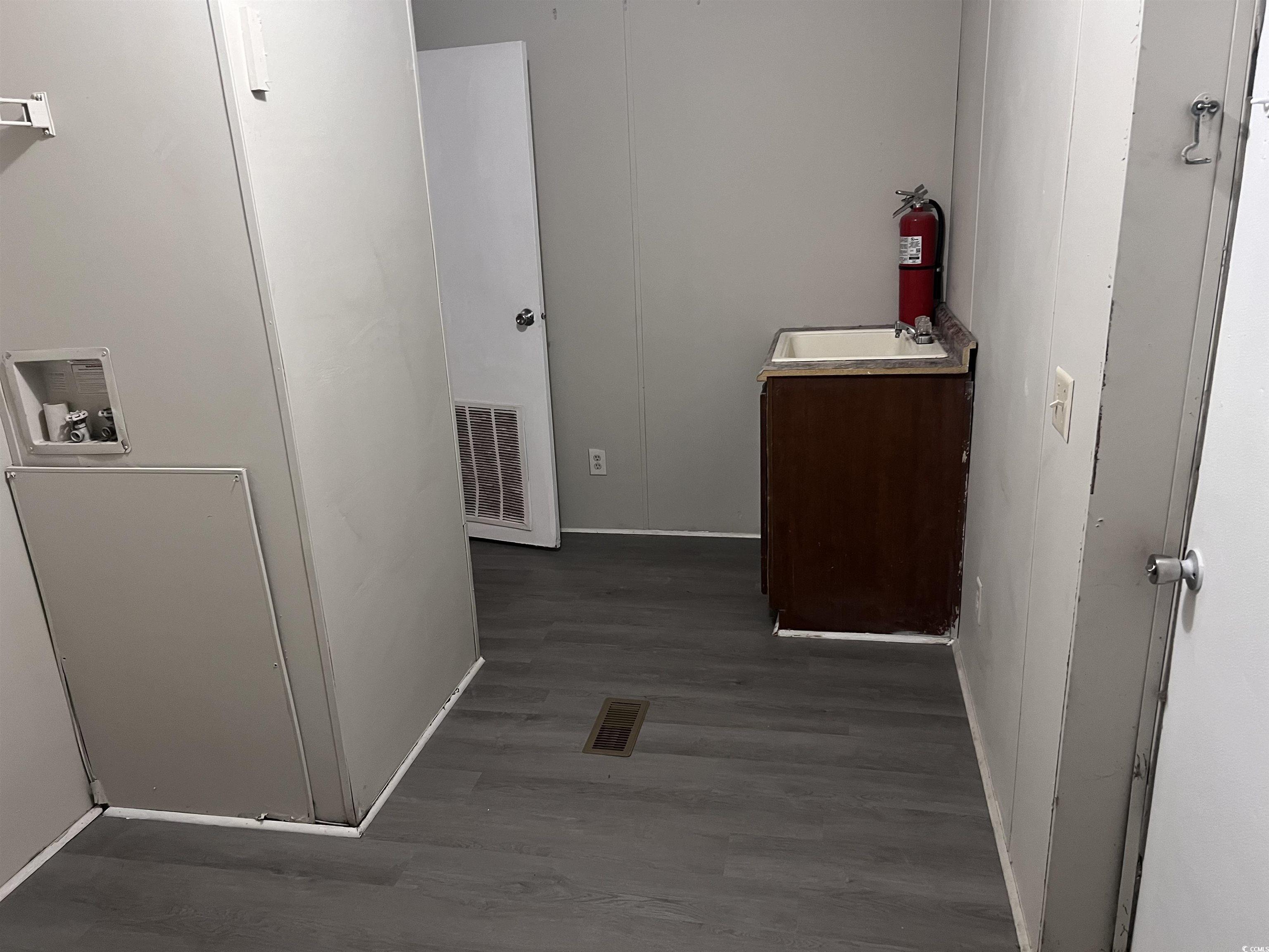 159 Jeffcoat Bridge Road North, SC 29112 - Photo 15 of 17 Hallway featuring wood finished floors and a sink