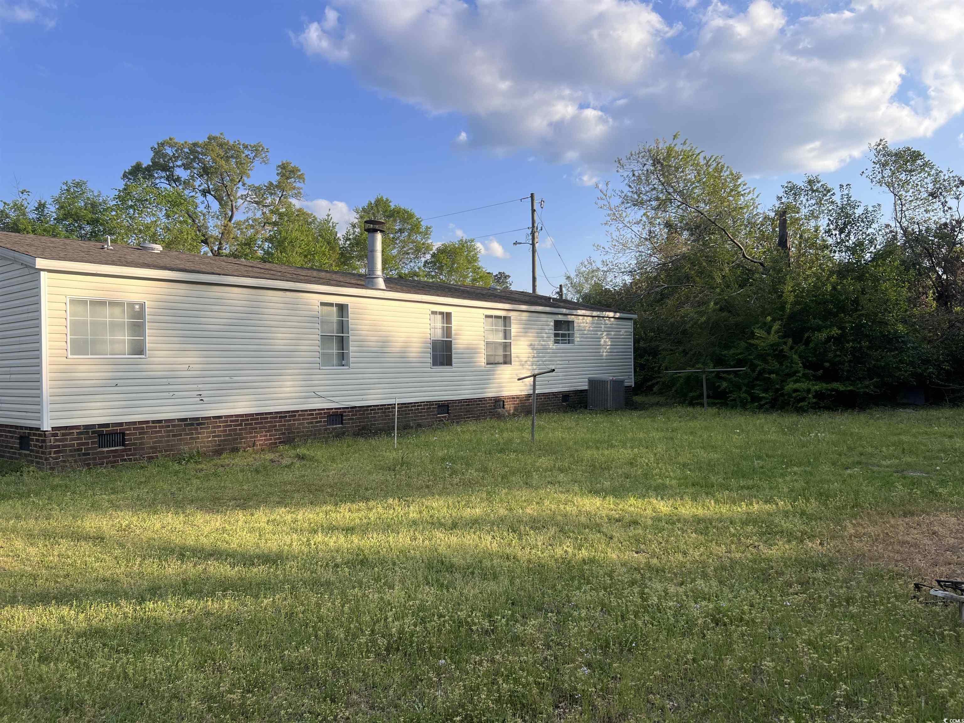 159 Jeffcoat Bridge Road North, SC 29112 - Photo 3 of 17 Rear view of house with crawl space and a yard