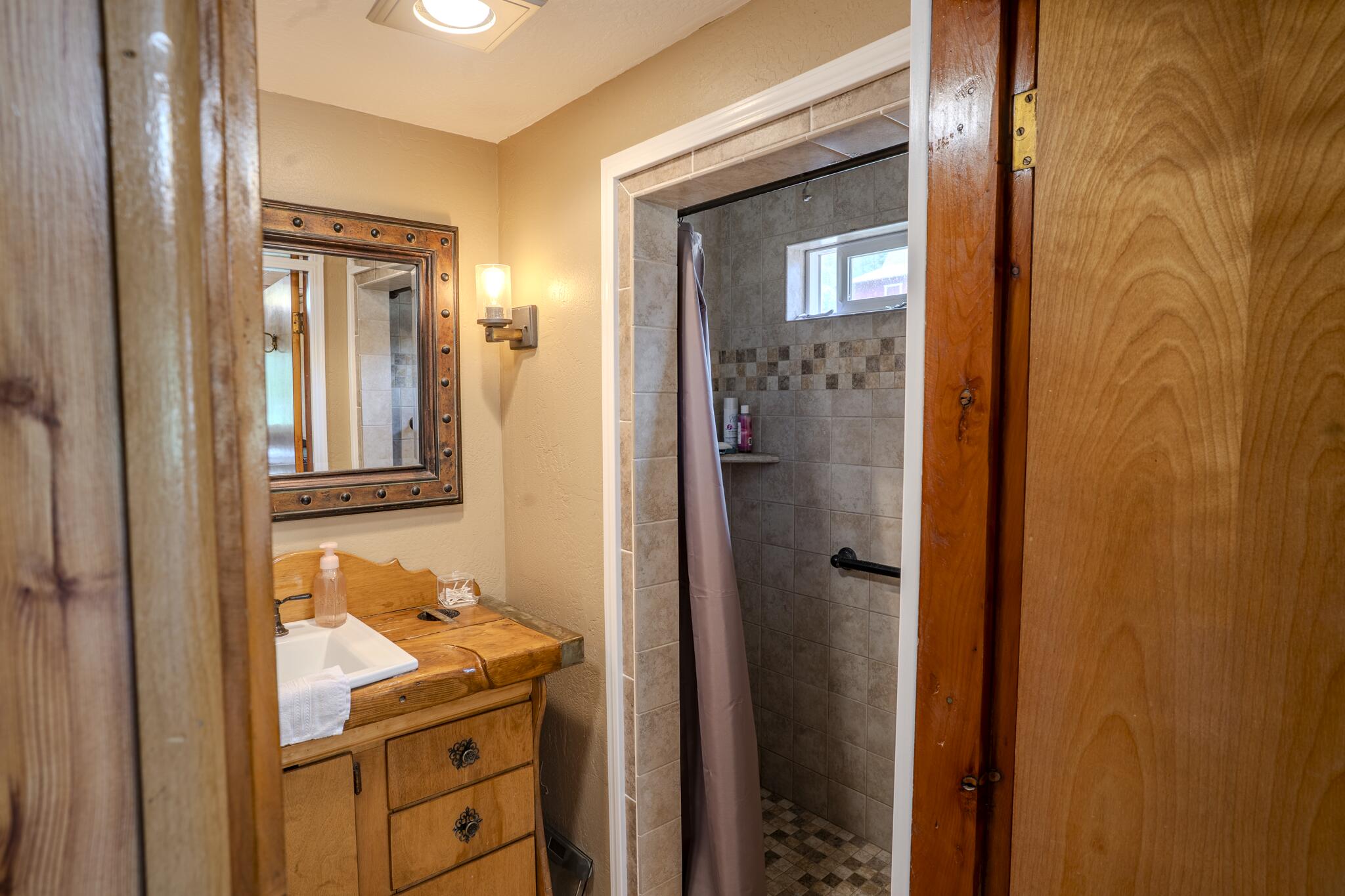 1969 Colestin Road Ashland, OR 97520 - Photo 48 of 72 a bathroom with a granite countertop sink and mirror