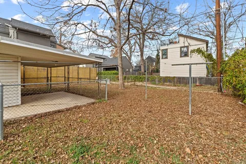 a view of a backyard with a large tree