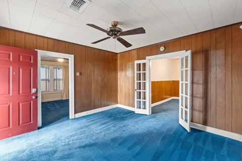 a view of empty room with wooden floor