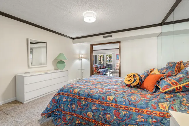 a bedroom with a bed and a dresser in it